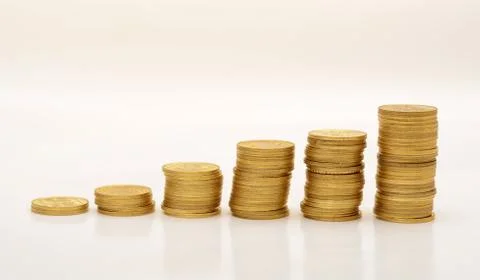 Stack of Golden Coins on White background with reflection Stock Photos