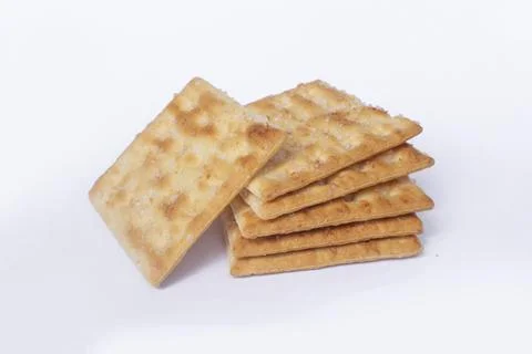 Stack of Golden Crackers on White Background Stock Photos
