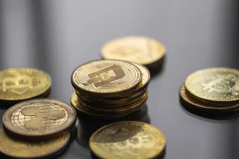 Stack of golden Dash bitcoin coin with a lot of bitcoins coins on a table Stock Photos