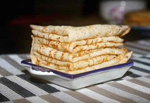 Stack of golden homemade pancakes on a square plate Stock Photos