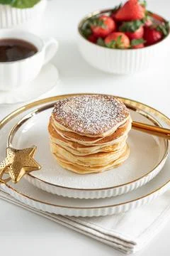 Stack of Golden Pancakes Dusted with Powdered Sugar with Strawberry and  Co.. Stock Photos