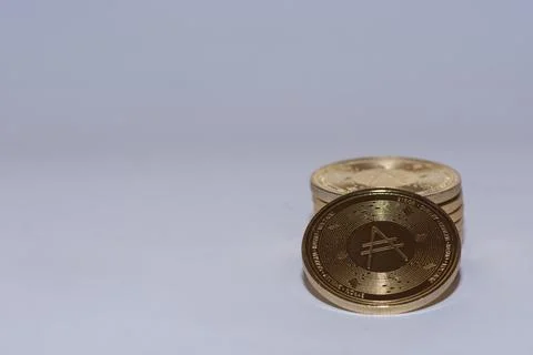 Stack of golden valueable ada coins from crypto currency with gray Stock Photos