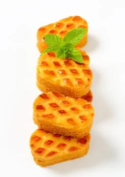 Stack of golden waffle pieces with mint leaf Stock Photos