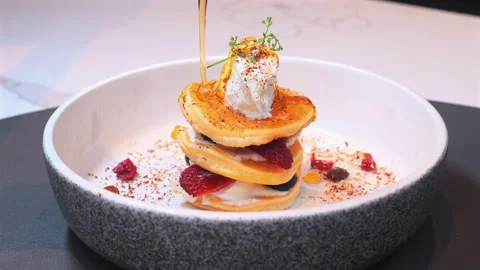 Stack of gourmet pancakes topped with whipped cream, fresh berries, Stock Footage 280179097