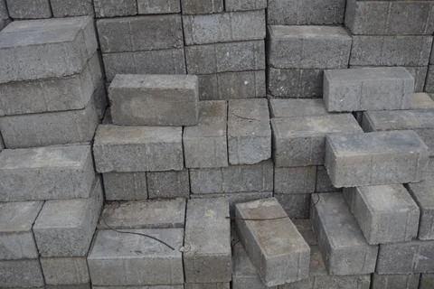 Stack of gray bricks for building construction Stock Photos
