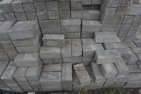 Stack of gray bricks for building construction Stock Photos
