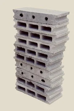 Of stack gray bricks, one with an open hole and the other with multiple small ho Stockfoto's
