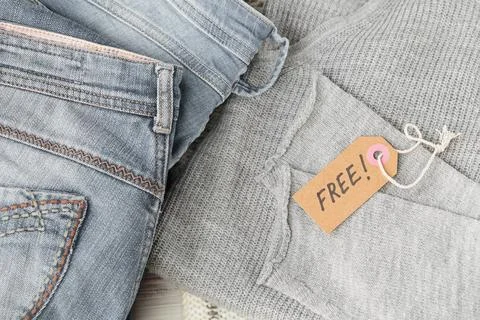 Stack of gray jeans and tag with inscription free Stock Photos