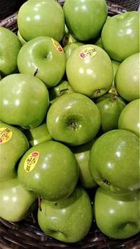 Stack green apples in baskets looks fresh Stock Photos