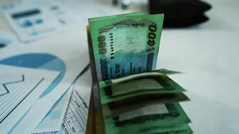 Stack of Green Banknotes with Financial Documents, A stack of green banknot.. Stock Footage 304961141