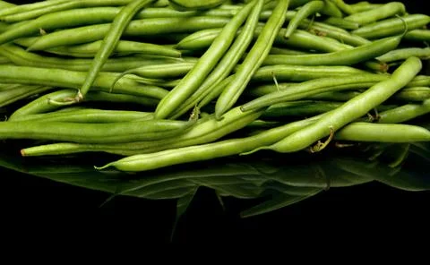 Stack of green beans on black background Stock Photos