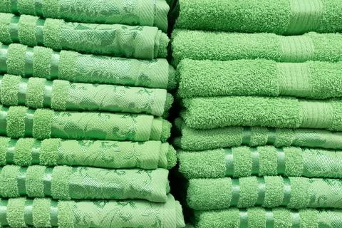 A stack of green fluffy towels in close-up Stock Photos