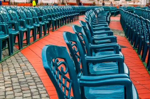 Stack of green plastic chair in the city square Stock Photos