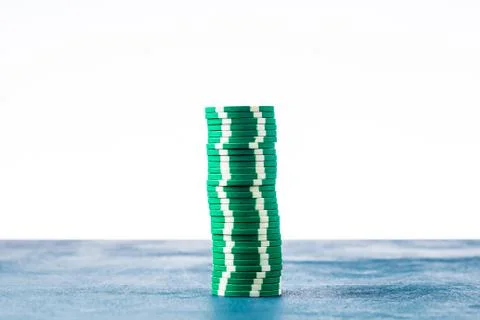 Stack of green poker chips on white background isolate Stock Photos