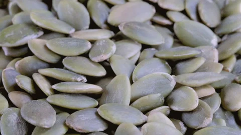 Stack of green pumpkin seeds without shells. Slider shot. Stock Footage 296538828