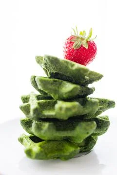 Stack of Green Spinach Waffles with Fresh Strawberry on Top Stock Photos
