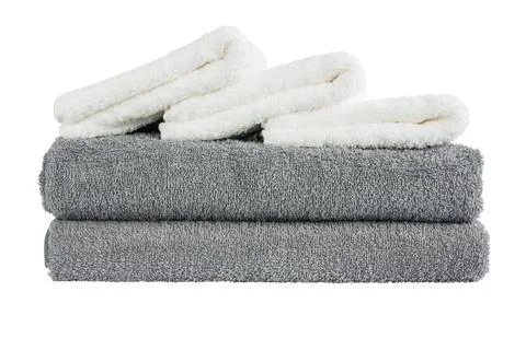 Stack of grey and white bath towels. Isolated over white background Stock Photos