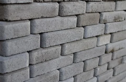 Stack of grey concrete paving stones and interlocking blocks, construction .. Stock Photos