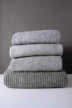 Stack of grey knit sweaters Stock Photos