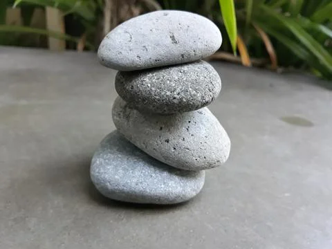 A stack of grey pebbles on grey base Stock Photos
