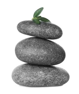Stack of grey spa stones and fresh leaves isolated on white 写真素材