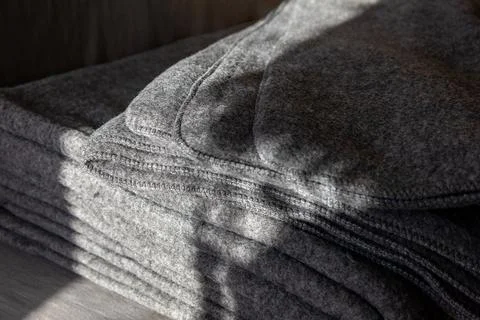 Stack of grey warm fleece blankets. Stock Photos
