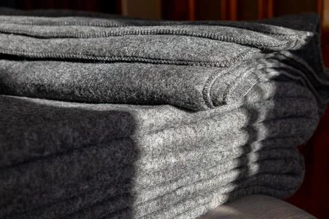 Stack of grey warm fleece blankets. Stock Photos