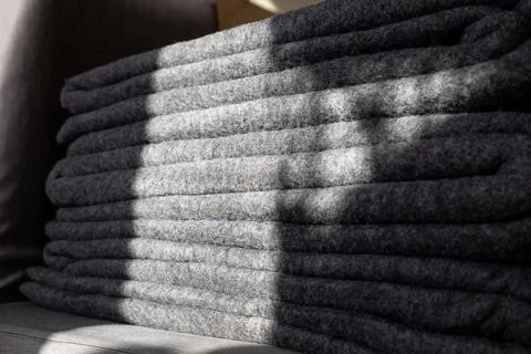 Stack of grey warm fleece blankets. Stock Photos