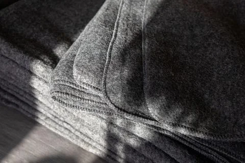 Stack of grey warm fleece blankets. Stock Photos