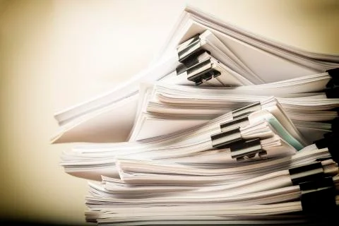 Stack of grunge document paper with colorful paperclip with copy space Stock Photos