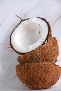 Stack of halved coconuts on a marble background Stock Photos
