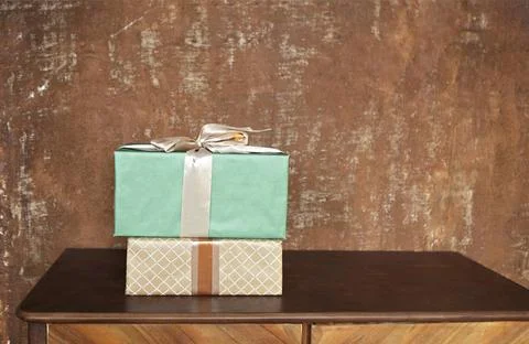 Stack of handcraft gift boxes on wooden board with a natural textured back... Stock Photos
