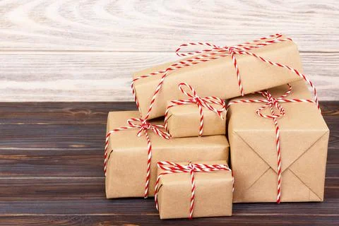 Stack of handcraft gift boxes on wooden board with a natural textured backgro Foto stock