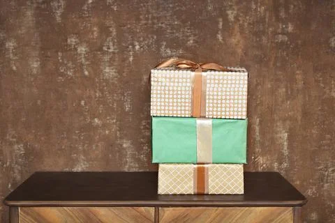 Stack of handcraft gift boxes on wooden board with a natural textured brown Stock Photos