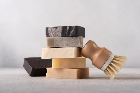 Stack of handcrafted soap bars and bamboo brush. Natural, organic cleaning co 写真素材