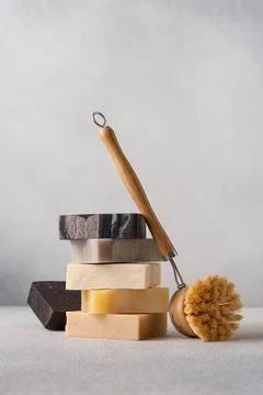 Stack of handcrafted soap bars and bamboo brush. Natural, organic cleaning co Stock Photos