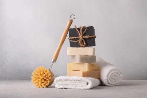 Stack of handcrafted soap bars, white terry towels and clean brush. Natural,  Stock Photos