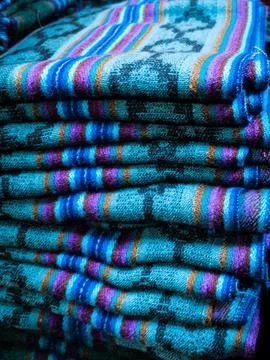 Stack of handmade Andean wool blankets at Otavalo Market Ecuador Stock Photos