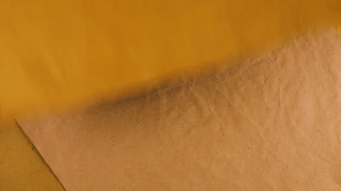 Stack of handmade paper in warm ochre, terracotta, vintage leather and mustard. Video stock 330240446