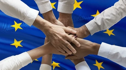 Stack of hands showing unity and teamwork over waving european union flag Stock Footage 122336990