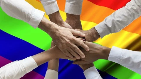 Stack of hands team over Rainbow or peace or gay flag waving loop animation Stock Footage 121928156