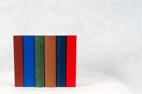 Stack of hardback books on table Stock Photos