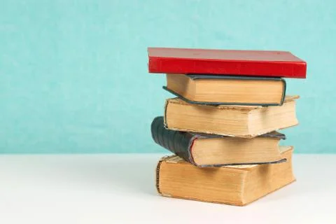 Stack of hardback books on table Stock Photos