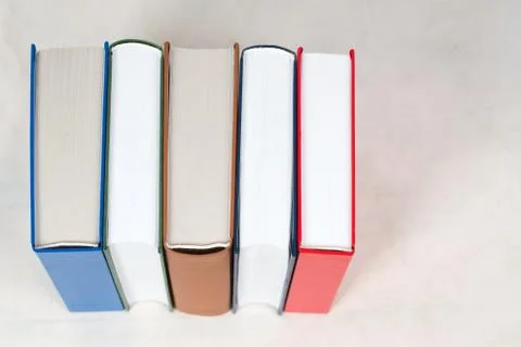 Stack of hardback books on table Stock Photos