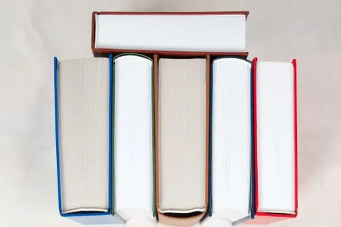 Stack of hardback books on table Stock Photos