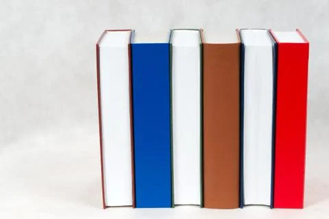 Stack of hardback books on table Stock Photos