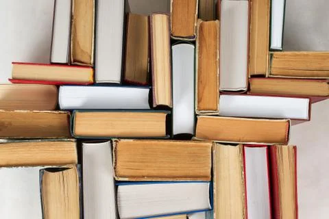 Stack of hardback books on table. Top view Stock Photos