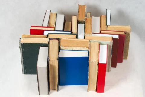 Stack of hardback books on table. Top view Stock Photos