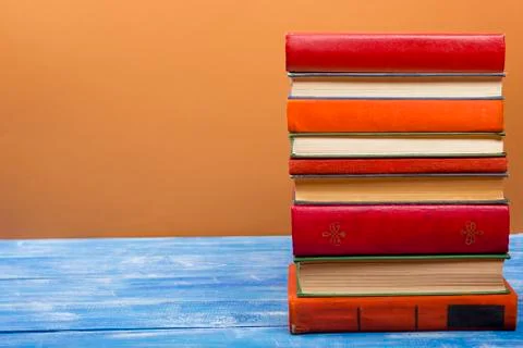 Stack of hardback books on wooden table. Back to school. Copy space for text Stock Photos