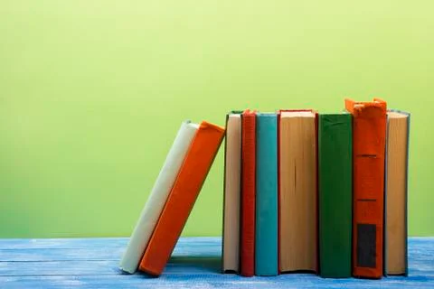 Stack of hardback books on wooden table. Back to school. Copy space for text Stock Photos